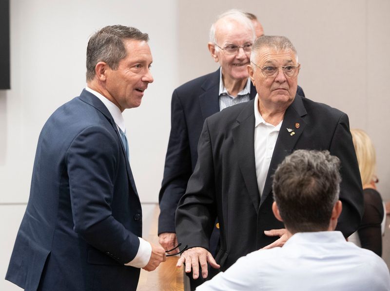 Sean Hollonbeck, left, talks with a group of supporters during his trial on Aug. 26, 2025. Hollonbeck was acquitted of aggravated assault and false imprisonment after holding a ride-share driver at gunpoint for dropping his daughter off at his home in 2024.