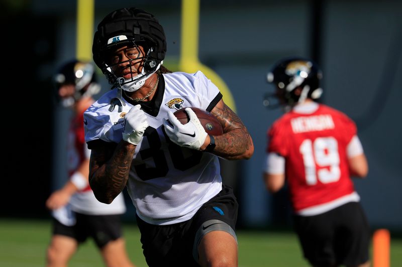 Jacksonville Jaguars running back Ja'Quinden Jackson (38) runs the ball during an NFL training camp session at the Miller Electric Center, Monday, Aug. 11, 2025 in Jacksonville, Fla. [Corey Perrine/Florida Times-Union]