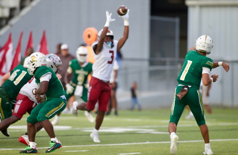 Lincoln football's Taylor Jacobs has a pass deflected by Madison County's O'mari Minor as the Trojans beat the Cowboys 23-12 on Thursday, Aug. 28, 2025 at Gene Cox Stadium