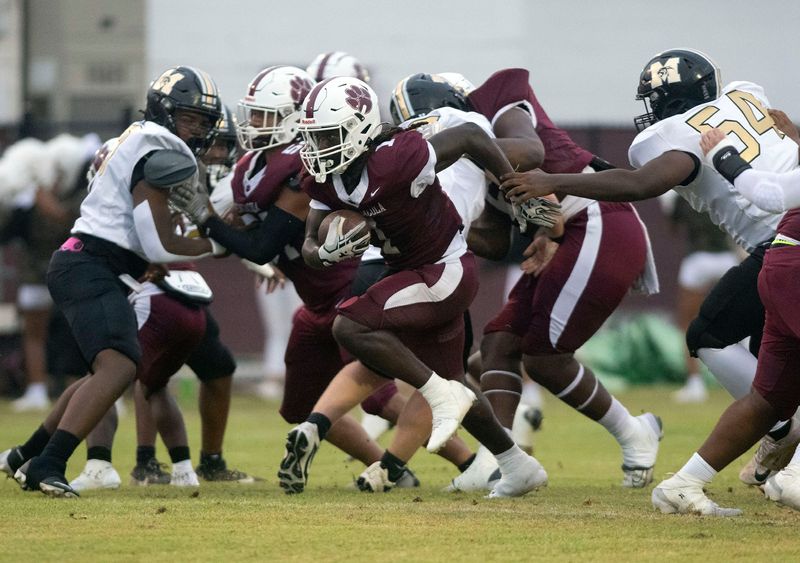 Pensacola High School's Courtney George (No. 1) rushes his way through the Milton defense during the Tigers' home game against the Panthers on Aug. 29, 2025.