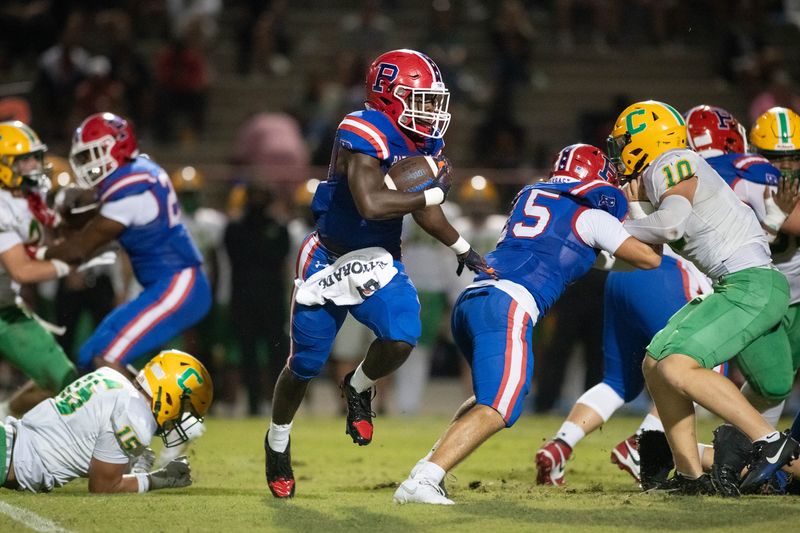 Patriots Makael Williams (20) carries the ball during the Pensacola Catholic vs Pace football game at Pace High School on Aug. 29, 2025.