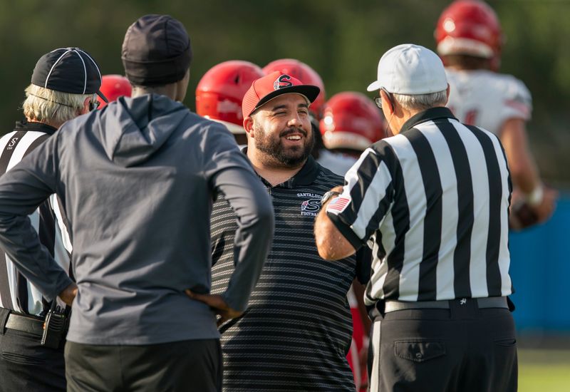 Santaluces head coach Hector Clavijo talks to the officials before game against the Gators in Palm Beach Gardens, Florida, on August 29, 2025.