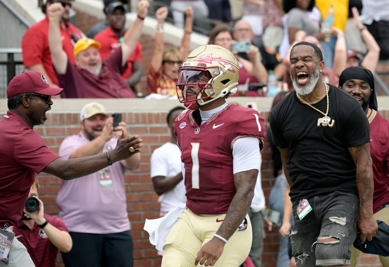 Florida State Seminoles quarterback Tommy Castellanos (1) celebrates with Peter Warrick (back) after scoring a touchdown Aug. 30, 2025, against the Alabama Crimson Tide during the first half at Doak S. Campbell Stadium in Tallahassee, Florida.