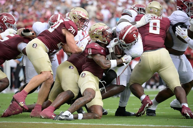 Alabama Crimson Tide running back Richard Young (9) runs with the ball Aug. 30, 2025, against Florida State Seminoles defensive back Earl Little Jr. (0) during the first half at Doak S. Campbell Stadium in Tallahassee, Florida.