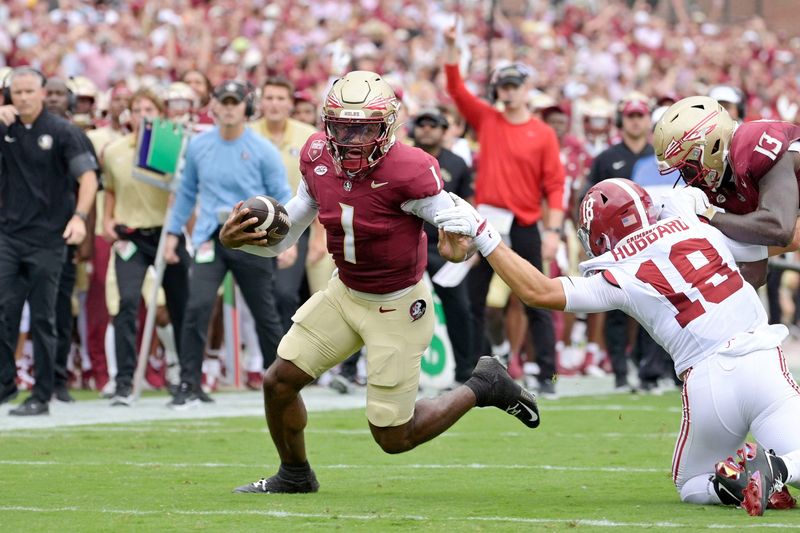 Aug 30, 2025; Tallahassee, Florida, USA; Florida State Seminoles quarterback Tommy Castellanos (1) runs for a touchdown against the Alabama Crimson Tide during the first half at Doak S. Campbell Stadium. Mandatory Credit: Melina Myers-Imagn Images
