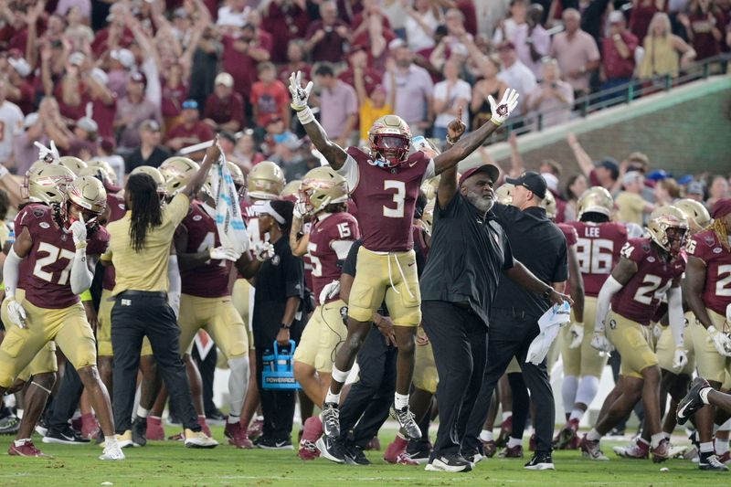 Aug 30, 2025; Tallahassee, Florida, USA; Florida State Seminoles running back Kam Davis (3) and associate head coach Odell Haggins react after a play Alabama Crimson Tide during the second half at Doak S. Campbell Stadium. Mandatory Credit: Melina Myers-Imagn Images