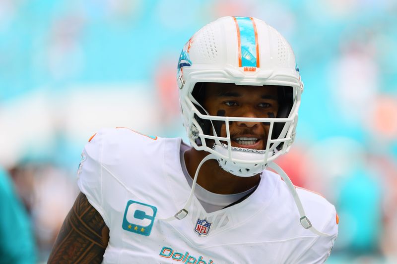 Oct 27, 2024; Miami Gardens, Florida, USA; Miami Dolphins quarterback Tua Tagovailoa (1) looks on before the game against the Arizona Cardinals at Hard Rock Stadium. Mandatory Credit: Sam Navarro-Imagn Images