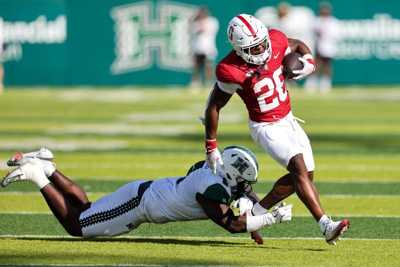 Aug 23, 2025; Honolulu, Hawaii, USA; Hawaii Rainbow Warriors defensive lineman Tariq Jones (5) tries to tackle Stanford Cardinal running back Sedrick Irvin (26) during the second half at Clarence T.C. Ching Athletics Complex. Mandatory Credit: Marco Garcia-Imagn Images