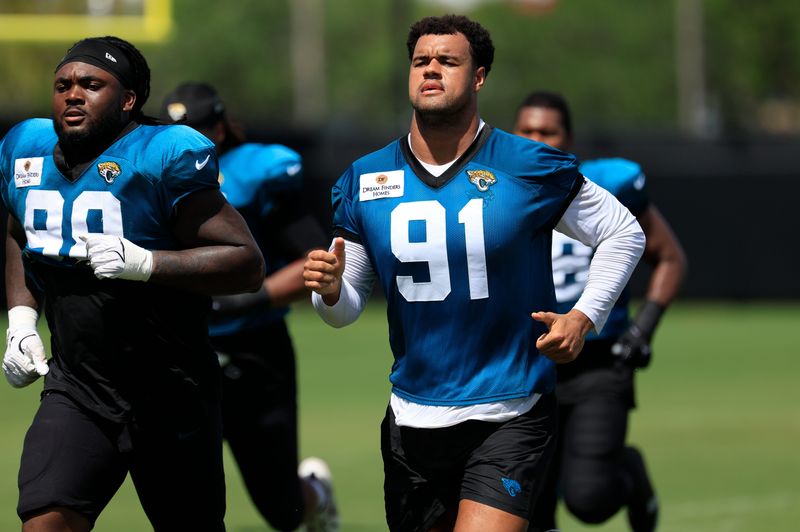 Jacksonville Jaguars defensive end Arik Armstead (91) runs after an NFL training camp session at the Miller Electric Center, Thursday, Aug. 14, 2025 in Jacksonville, Fla.