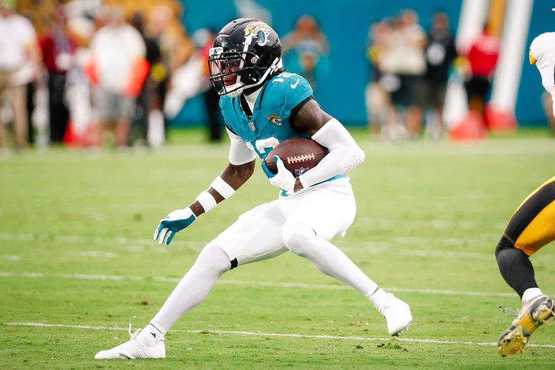 Aug 9, 2025; Jacksonville, Florida, USA; Jacksonville Jaguars wide receiver Travis Hunter (12) runs after a catch against the Pittsburgh Steelers during a preseason game at EverBank Stadium. Mandatory Credit: Travis Register-Imagn Images