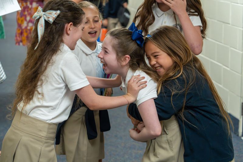 A group of Palm Beach Day Academy upper school students show how excited they are to see each other on the first day of classes Sept. 2.