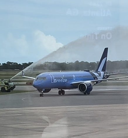 Airport fire trucks give a water cannon salute to the inaugural incoming Breeze Airways flight to Daytona Beach International Airport from Akron-Canton, Ohio, late afternoon Wednesday, Sept. 3, 2025. Breeze now offers twice-weekly nonstop flights on Wednesdays and Saturdays on its new Daytona Beach-Akron/Canton/Cleveland route. Akron-Canton Airport is roughly an hour drive by car to Cleveland.