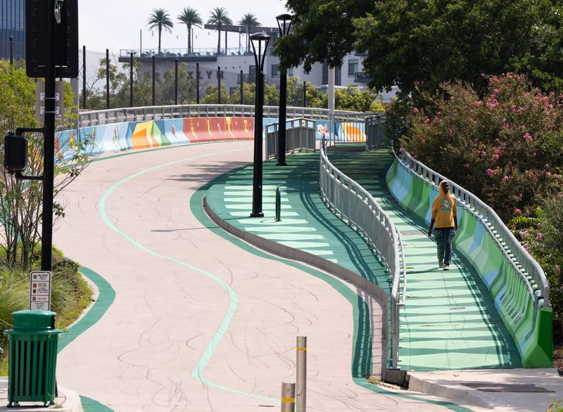 A pedestrian walk along the Emerald Trail mural on Park Street near Prime Osborn Convention Center Wednesday August 27, 2025.[Doug Engle/Florida Times-Union]