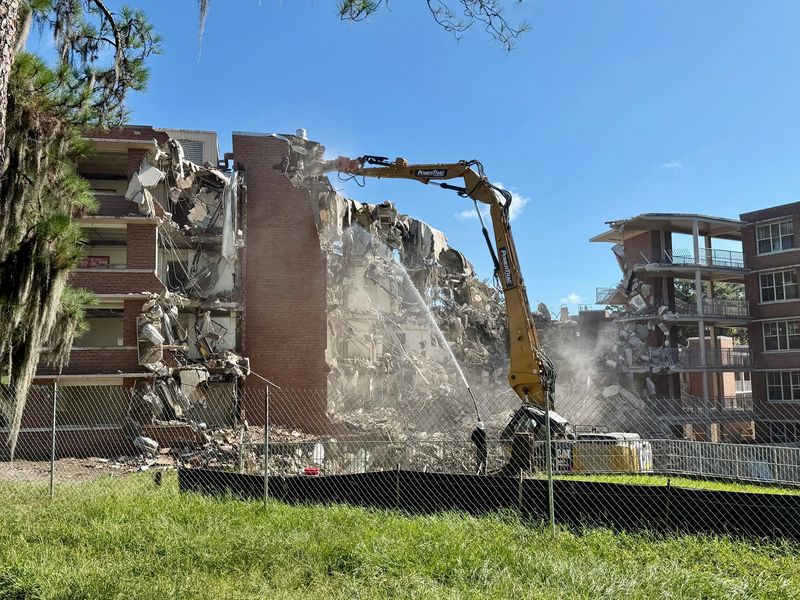 A crane operator on Sept. 4, 2025, demolishes Trusler and Simpson Halls to make way for new student housing near the corner of Museum Road and Gale Lemerand Drive on the University of Florida campus.