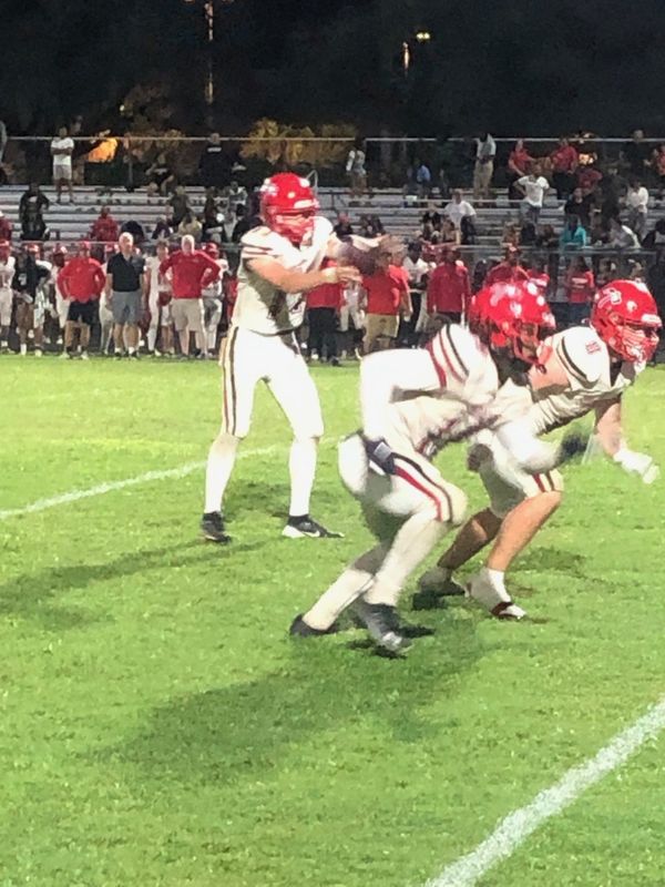 Santaluces quarterback Jaxson Mariconi (left) takes a snap against Boynton Beach on Thursday, Sept. 4, 2025 in Boynton Beach.