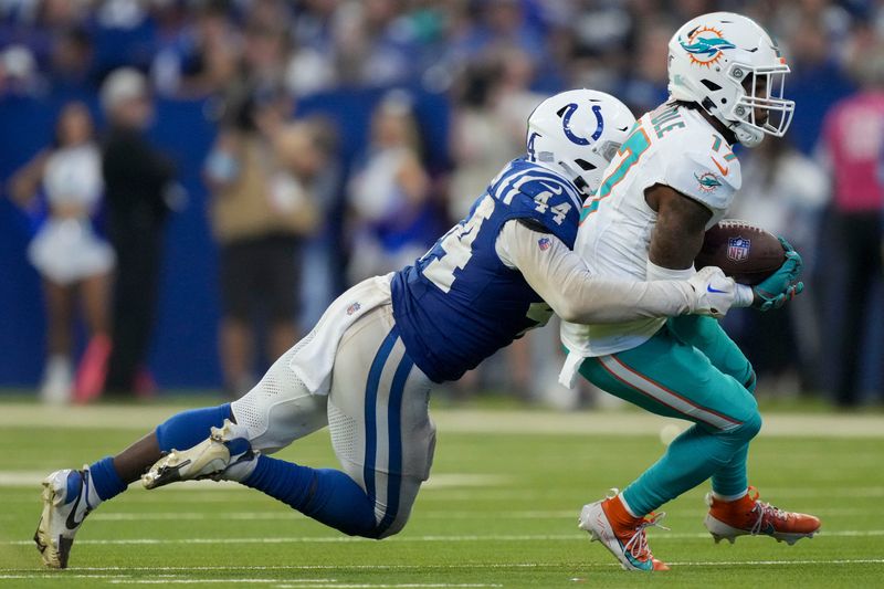 Oct 20, 2024; Indianapolis, Indiana, USA; Indianapolis Colts linebacker Zaire Franklin (44) works to bring down Miami Dolphins wide receiver Jaylen Waddle (17) during a game against the Miami Dolphins at Lucas Oil Stadium . Mandatory Credit: Christine Tannous/IndyStar USA TODAY Network via Imagn Images