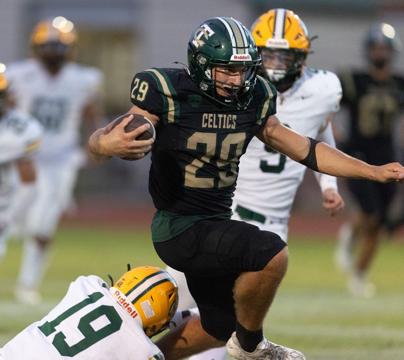 Trinity Catholic Wyatt Lucas (29) gets by Forest Tevin Hargrove (19) FHSAA football game at Trinity Catholic in Ocala, FL on Friday, September 5, 2025. [Alan Youngblood/Ocala Star-Banner]