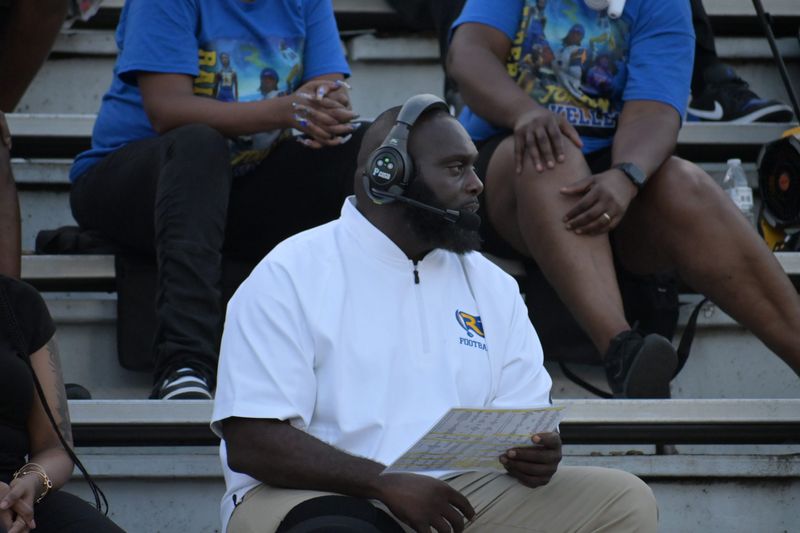 Rickards Raiders head coach Quintin Lewis calls plays from the bleachers versus the Mosley Dolphins in a Week 3 FHSAA football matchup at Gene Cox Stadium in Tallahassee, Florida, Friday, Sept. 5, 2025. Lewis suffered a tibial plateau fracture a day before his team played.