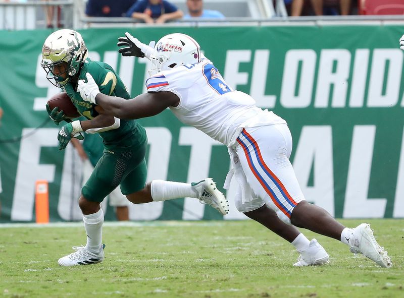 Florida Gators defensive lineman Zachary Carter (6) chases down South Florida Bulls running back Brian Battie (21) for a tackle behind the line during the second game of the season against the USF Bulls at Raymond James Stadium, in Tampa Fla. Sept. 11, 2021.

Flgai 09112021 Ufvs Usf Action05