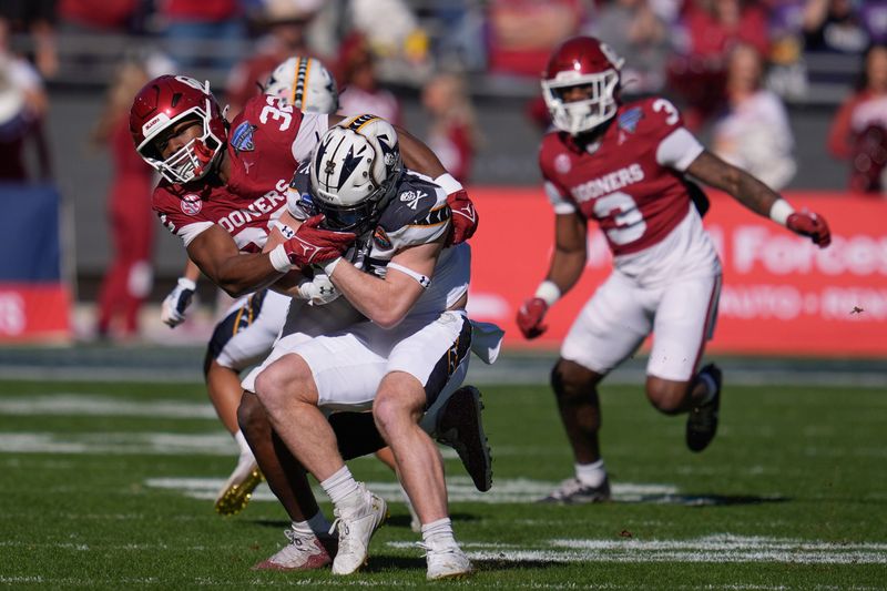 Oklahoma Sooners defensive lineman R Mason Thomas (32) brings down Navy Midshipmen fullback Alex Tecza (46) during the Armed Forces Bowl football game between the University of Oklahoma Sooners (OU) and the Navy Midshipmen at Amon G. Carter Stadium in Fort Worth, Texas, Friday, Dec. 27, 2024.