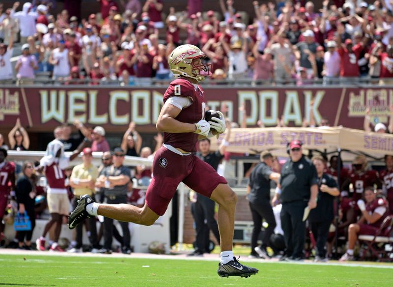 Sep 6, 2025; Tallahassee, Florida, USA; Florida State Seminoles wide receiver Duce Robinson (0) catches a touchdown during the first half against the East Texas A&M at Doak S. Campbell Stadium. Mandatory Credit: Melina Myers-Imagn Images