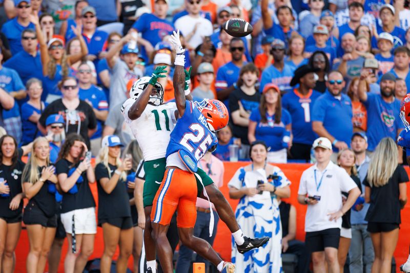 Sep 6, 2025; Gainesville, Florida, USA; Florida Gators defensive back Cormani McClain (25) breaks up a pass to South Florida Bulls fullback D.J. Harris (11) during the first half at Ben Hill Griffin Stadium. Mandatory Credit: Matt Pendleton-Imagn Images