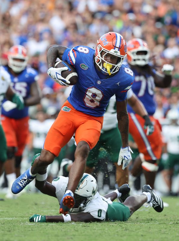 Sep 6, 2025; Gainesville, Florida, USA; Florida Gators wide receiver Vernell Brown III (8) runs past South Florida Bulls cornerback Jarvis Lee (0) during the second half at Ben Hill Griffin Stadium. Mandatory Credit: Kim Klement Neitzel-Imagn Images
