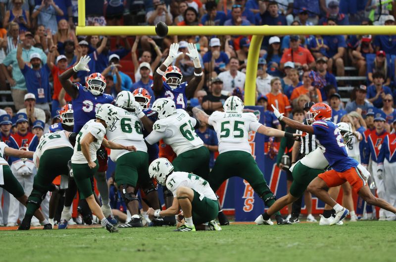 Sep 6, 2025; Gainesville, Florida, USA; South Florida Bulls place kicker Nico Gramatica (7) kicks a field goal against the Florida Gators during the second quarter at Ben Hill Griffin Stadium. Mandatory Credit: Kim Klement Neitzel-Imagn Images
