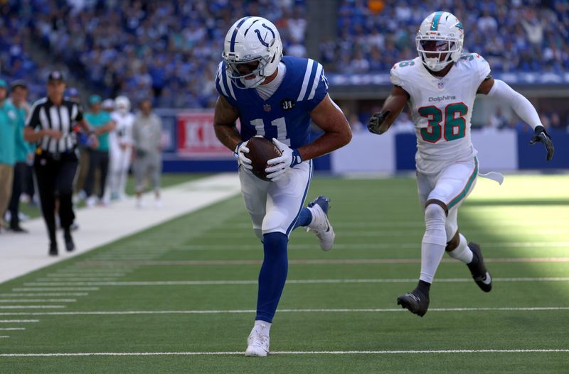 Sep 7, 2025; Indianapolis, Indiana, USA; Indianapolis Colts wide receiver Michael Pittman Jr. (11) catches a touchdown against Miami Dolphins cornerback Storm Duck (36) during the first half at Lucas Oil Stadium. Mandatory Credit: Trevor Ruszkowski-Imagn Images