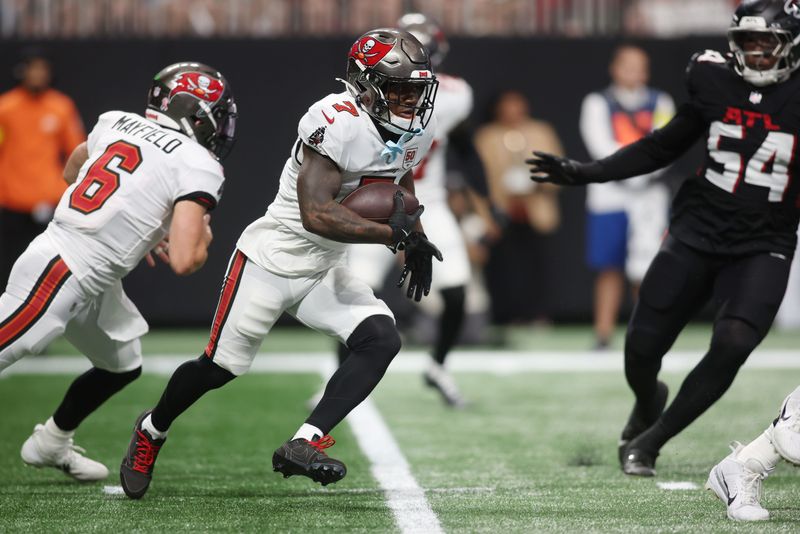 Sep 7, 2025; Atlanta, Georgia, USA; Tampa Bay Buccaneers running back Bucky Irving (7) runs with the ball against the Atlanta Falcons during the first quarter at Mercedes-Benz Stadium. Mandatory Credit: Brett Davis-Imagn Images