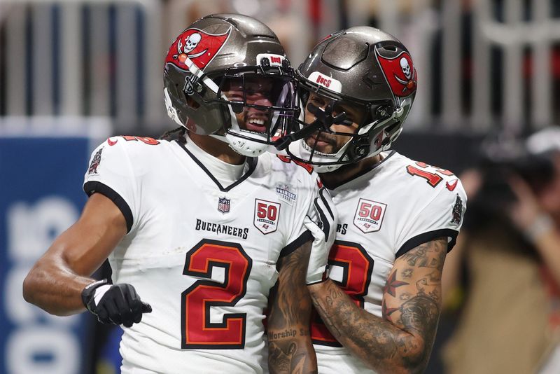 Sep 7, 2025; Atlanta, Georgia, USA; Tampa Bay Buccaneers wide receiver Emeka Egbuka (2) celebrates with wide receiver Mike Evans (13) after scoring a touchdown against the Atlanta Falcons during the second quarter at Mercedes-Benz Stadium. Mandatory Credit: Brett Davis-Imagn Images