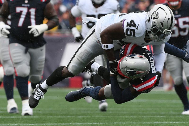 Sep 7, 2025; Foxborough, Massachusetts, USA; Las Vegas Raiders linebacker Devin White (45) tackles New England Patriots wide receiver Kayshon Boutte (9) at Gillette Stadium. Mandatory Credit: Bob DeChiara-Imagn Images