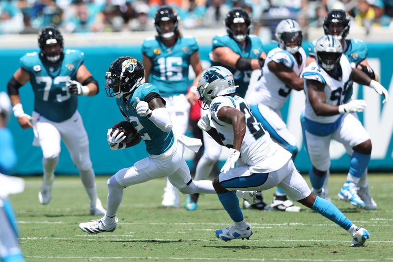 Sep 7, 2025; Jacksonville, Florida, USA; Jacksonville Jaguars wide receiver Travis Hunter (12) runs after the catch against the Carolina Panthers during the first half at EverBank Stadium. Mandatory Credit: Morgan Tencza-Imagn Images