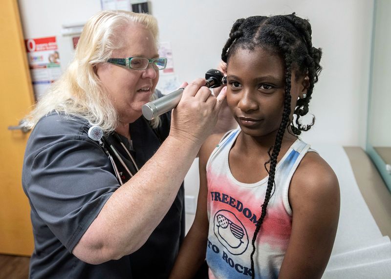 Dr. Marian Stewart begins the examination of 9-year-old patient, Joyce Wesley, at the Community Health Northwest Florida site on Century on Sept. 8, 2025. Rural doctors like Stewart can see as many as 20-30 patients a day