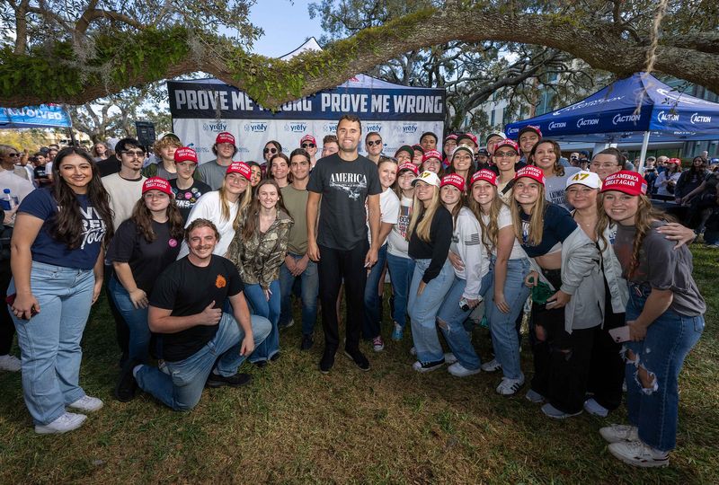 Members of the Southeastern University chapter of Turning Point USA pose with the group's founder, Charlie Kirk, during a stop on his American Comeback Tour at the University of South Florida in spring 2025.