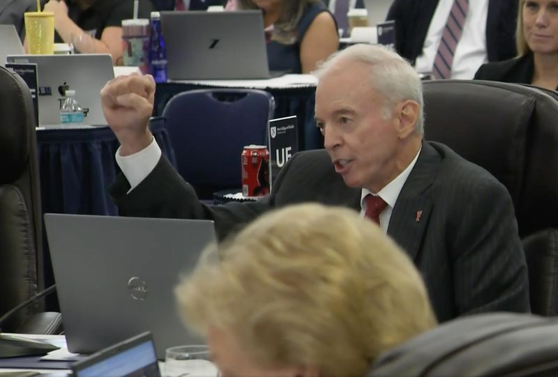 Dr. Donald Landry, the University of Florida's new interim president, gives a fist pump as he says "Go Gators!" following his opening remarks on Sept 11 to the Florida Board of Governors.