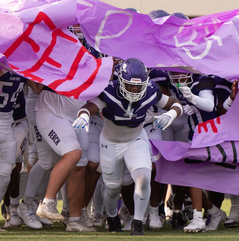 The Fletcher High School football team break through a banner at the start of the game. Fletcher hosted Nease High School Friday night at Fletcher High School at Jack Taylor Stadium in Jacksonville Beach, Fla. Friday September 12, 2025. [Doug Engle/Florida Times-Union]