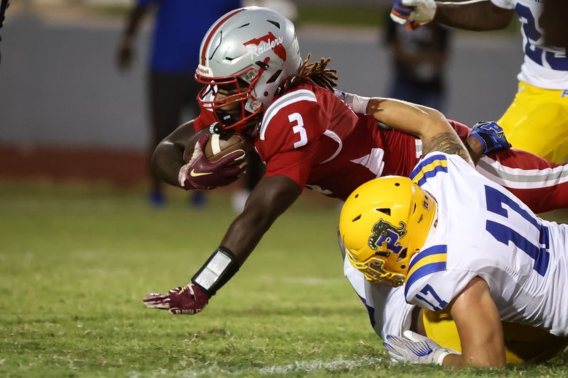 Palatka Panthers player Zane Leger (17) tackles Santa Fe Raiders player Jasiah Powell (3) during the first half of a football game between Santa Fe High School and Palatka High School at Santa Fe High School in Alachua, FL on Friday, September 12, 2025. [Chris Watkins/Gainesville Sun]