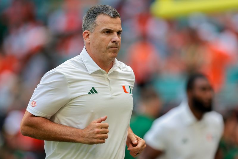 Miami Hurricanes head coach Mario Cristobal runs on the field before the game Sept. 13, 2025, against the South Florida Bulls at Hard Rock Stadium in Miami Gardens, Florida.