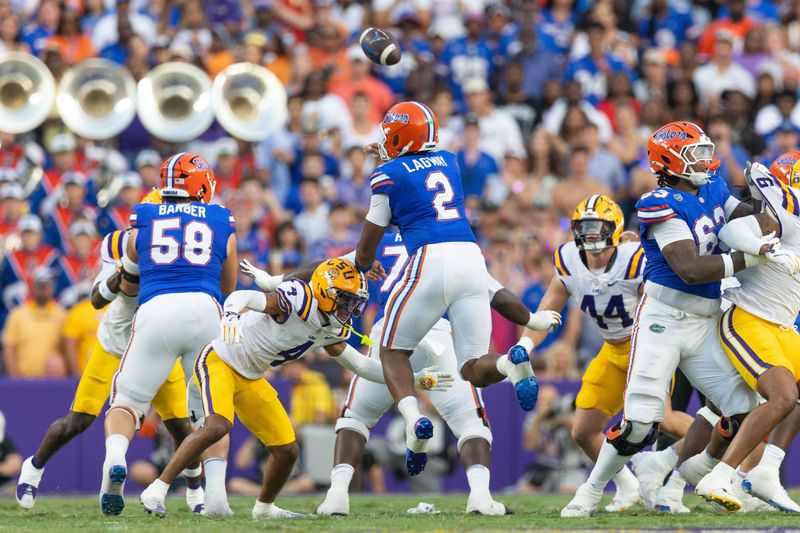 Sep 13, 2025; Baton Rouge, Louisiana, USA; Florida Gators quarterback DJ Lagway (2) leaps to pass the ball before being sacked by LSU Tigers cornerback Mansoor Delane (4) during the first half at Tiger Stadium. Mandatory Credit: Stephen Lew-Imagn Images