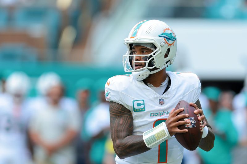 Sep 14, 2025; Miami Gardens, Florida, USA; Miami Dolphins quarterback Tua Tagovailoa (1) looks for a passing option against the New England Patriots during the first quarter at Hard Rock Stadium. Mandatory Credit: Sam Navarro-Imagn Images