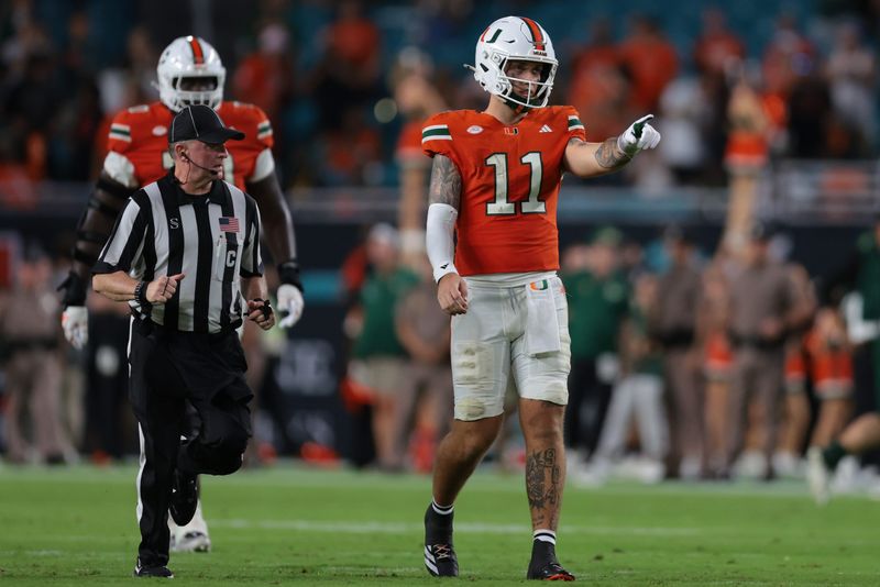 Sep 13, 2025; Miami Gardens, Florida, USA; Miami Hurricanes quarterback Carson Beck (11) reacts on the field against the South Florida Bulls during the fourth quarter at Hard Rock Stadium. Mandatory Credit: Sam Navarro-Imagn Images