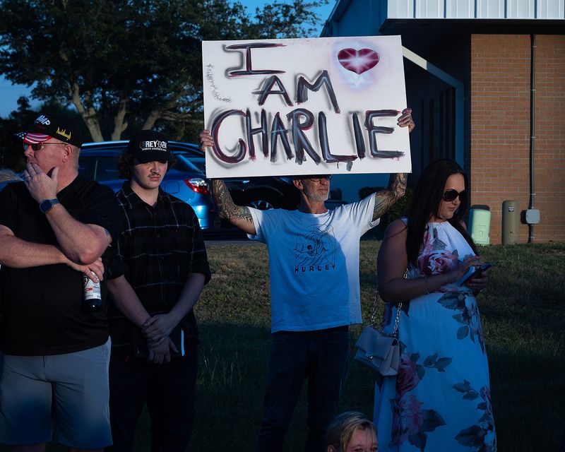 People at Carl Grey Park in Panama City, Fla., celebrate the life of Charlie Kirk Sept. 14, 2025. The conservative activist was murdered at a Utah university four days earlier. The candlelight vigil was organized by the Bay County Republican Party of Florida. (Tyler Orsburn/News Herald)