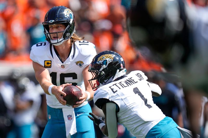 Jacksonville Jaguars wide receiver Chandler Brayboy (15) hands off to Jacksonville Jaguars running back Travis Etienne Jr. (1) in the first quarter of the NFL Week 2 game between the Cincinnati Bengals and the Jacksonville Jaguars at Paycor Stadium in downtown Cincinnati on Sunday, Sept. 14, 2025. The Jaguars led 17-10 at halftime.