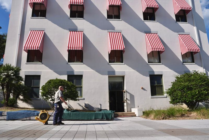 A man rolls an industrial fan into the Historic Capitol after a smoke incident occurred inside the building Monday, Sept. 15, 2025.