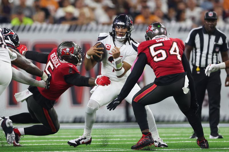 Sep 15, 2025; Houston, Texas, USA; Houston Texans quarterback C.J. Stroud (7) comes under pressure from Tampa Bay Buccaneers linebacker Lavonte David (54) and Tampa Bay Buccaneers linebacker Haason Reddick (5) during the third quarter at NRG Stadium. Mandatory Credit: Troy Taormina-Imagn Images