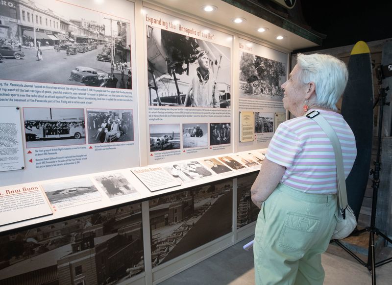 Kay Canfield looks at the new World War II micro exhibit after its unveiling at City Hall in downtown Pensacola on Sept. 16, 2025. The exhibit honors Pensacola and Escambia County’s designation as Florida’s only American World War II Heritage City.
