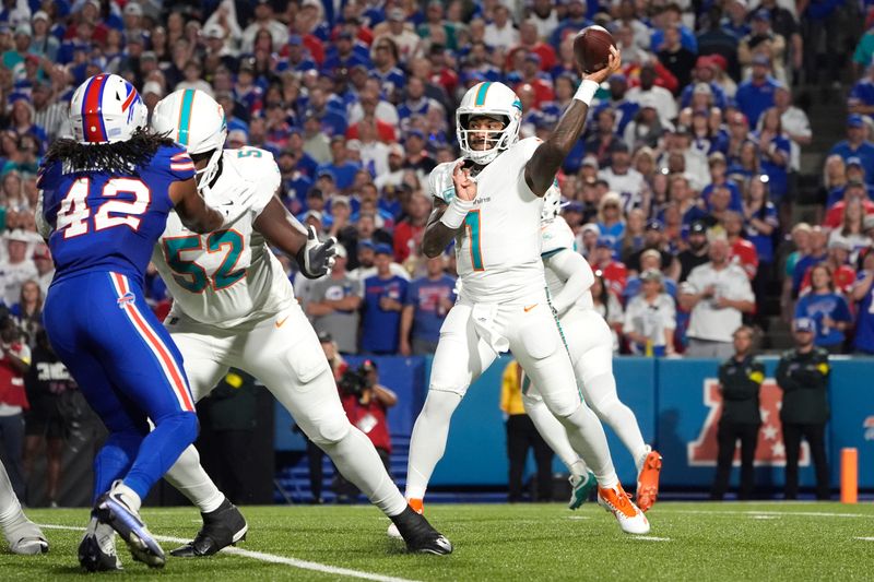 Sep 18, 2025; Orchard Park, New York, USA; Miami Dolphins quarterback Tua Tagovailoa (1) passes against the Buffalo Bills in the first quarter at Highmark Stadium. Mandatory Credit: Gregory Fisher-Imagn Images