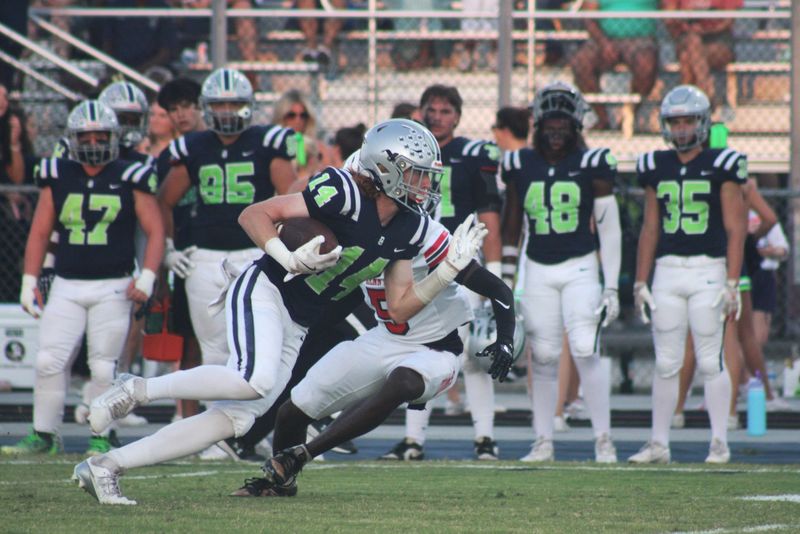 Beachside wide receiver Drew Aldrich (14) spins away from Bishop Kenny defensive back Jelani Dawkins (5) during a high school football game on Sept. 18, 2025. [Clayton Freeman/Florida Times-Union]