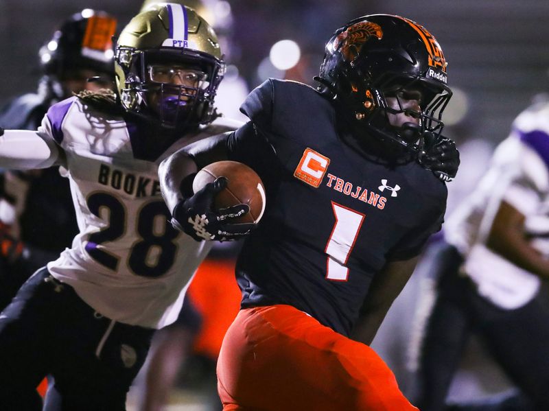 Lely Trojans kick returner Nino Joseph breaks a tackle from Sarasota Booker Tornadoes defender Octavious Edwards (28) during the second quarter of a Week 5 game at Lely High School in Naples, Fla., on Friday, Sept. 19, 2025.